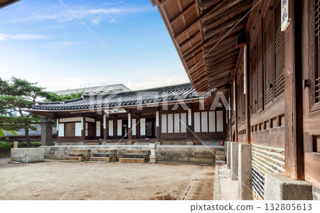 Korean traditional wooden halls and tiled roofs inside Unhyeongung Palace, showcasing Joseon-era architectural features and open courtyard spaces surrounded by trees Korean traditional wooden halls and tiled roofs inside Unhyeongung Palace, showcasing Joseon-era architectural features and open courtyard spaces surrounded by trees 132805613