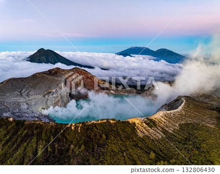 Aerial view of rock cliff at Kawah Ijen volcano with turquoise sulfur water lake at sunrise.Amazing nature landscape view at East Java, Indonesia.Natural landscape colorful sky background 132806430