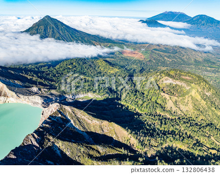 Aerial view of rock cliff at Kawah Ijen volcano with turquoise sulfur water lake at sunrise.Amazing nature landscape view at East Java, Indonesia.Natural landscape colorful sky background Aerial view of rock cliff at Kawah Ijen volcano with turquoise sulfur water lake at sunrise.Amazing nature landscape view at East Java, Indonesia.Natural landscape colorful sky background 132806438