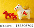 Cute horse and baby figurines lined up on a golden background. Ideal for the zodiac, New Year's, and New Year's cards. 132806705