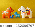 Four cute horse figurines lined up on a golden background - Zodiac, New Year, lucky charm image 132806707