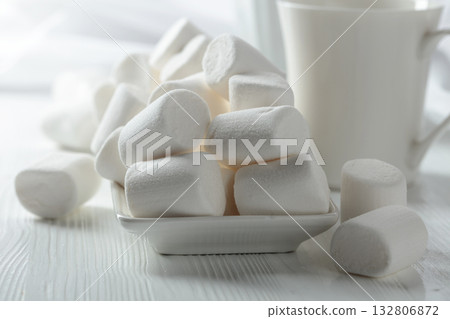 White marshmallows on a wooden table. White marshmallows on a wooden table. 132806872
