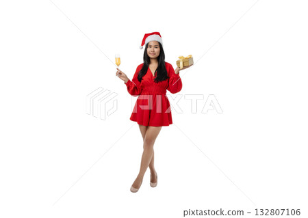 Festive woman celebrating Christmas with drink and gift, isolated, PNG 132807106