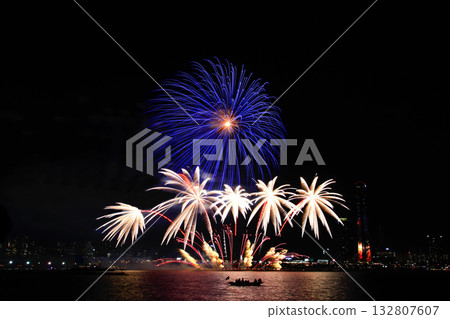 Colorful fireworks at night over the river. 132807607