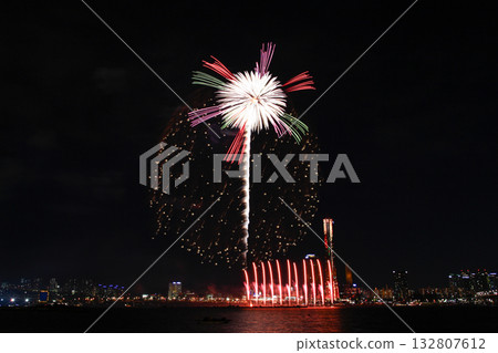 Colorful fireworks at night over the river. 132807612