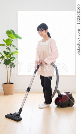 Woman vacuuming (AI-generated image) 132808160