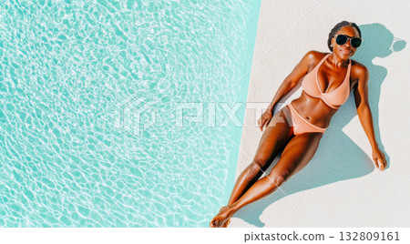 Black young woman relaxing by a swimming pool in swimsuit on sunny day, yop view, copy space Black young woman relaxing by a swimming pool in swimsuit on sunny day, yop view, copy space 132809161
