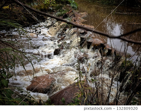 churning, foamy water on a river rapid on a bright summer day churning, foamy water on a river rapid on a bright summer day 132809320
