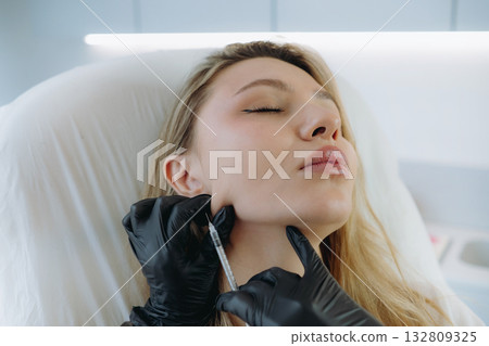young woman getting Mesotherapy facelifting procedure in aesthetic clinic. Beauty treatment young woman getting Mesotherapy facelifting procedure in aesthetic clinic. Beauty treatment 132809325