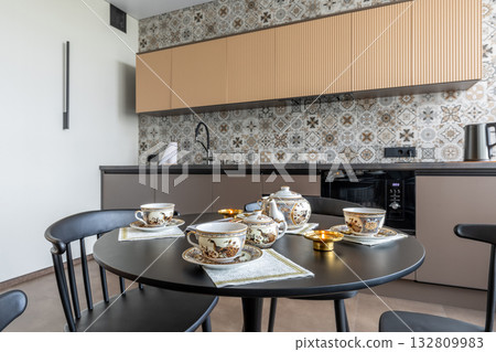 Porcelain Tea Set on Black Table in Modern Kitchen Interior Porcelain Tea Set on Black Table in Modern Kitchen Interior 132809983