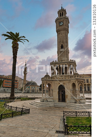 Historic Izmir Clock Tower and Konak Yali Mosque with a palm tree under a beautiful sky in Izmir, Turkey. 132810116