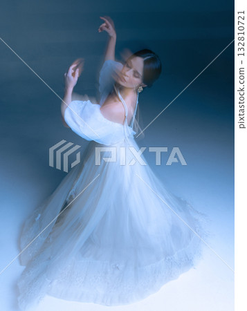 Twirling dancer in layered gown, arms curved in expressive elegant motion Twirling dancer in layered gown, arms curved in expressive elegant motion 132810721