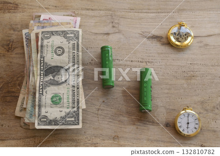energy costs concept with batteries money and time on wooden table energy costs concept with batteries money and time on wooden table 132810782