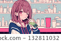 A girl drinking a drink at a cafe 132811032