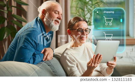 Senior couple online shopping using futuristic digital interface at home. Creative collage 132811183