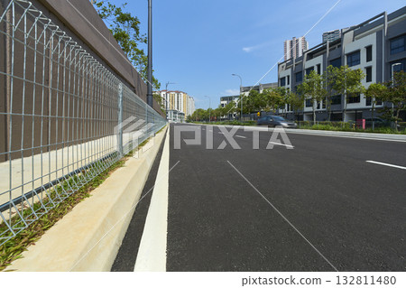 Asphalt road through modern residential townhouses area Asphalt road through modern residential townhouses area 132811480