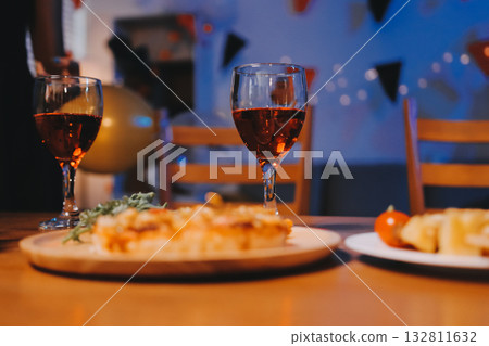 Joyful office Halloween party with coworkers in costumes, celebrating with drinks and laughter, fostering teamwork and festive spirit 132811632