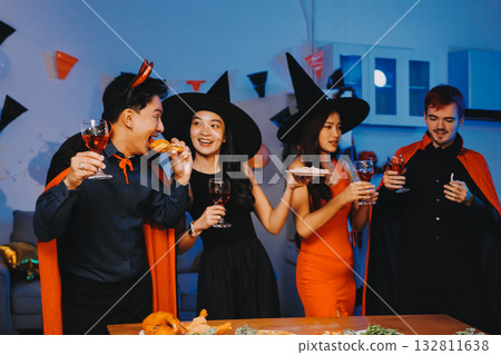 Joyful office Halloween party with coworkers in costumes, celebrating with drinks and laughter, fostering teamwork and festive spirit 132811638