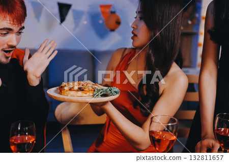 Joyful office Halloween party with coworkers in costumes, celebrating with drinks and laughter, fostering teamwork and festive spirit 132811657