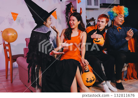 Joyful office Halloween party with coworkers in costumes, celebrating with drinks and laughter, fostering teamwork and festive spirit 132811676