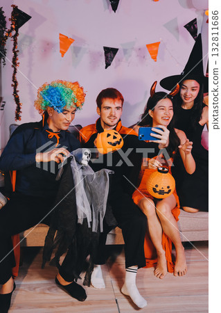 Joyful office Halloween party with coworkers in costumes, celebrating with drinks and laughter, fostering teamwork and festive spirit 132811686