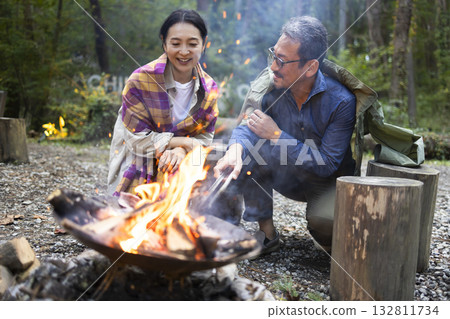 Family having a bonfire at a campsite Family having a bonfire at a campsite 132811734