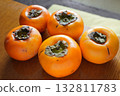 Aizu Minare persimmon on a wooden table Aizu Minare persimmon on a wooden table 132811783