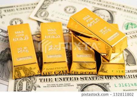 Gold bars on US dollar banknote money, finance trading investment business currency. Gold bars on US dollar banknote money, finance trading investment business currency. 132811802