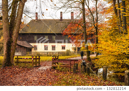 Visitors walk along a pathway leading to the historic House of Stare Belidlo in Granny Walley, surrounded by lush greenery and autumn colors. Visitors walk along a pathway leading to the historic House of Stare Belidlo in Granny Walley, surrounded by lush greenery and autumn colors. 132812214