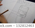 Child's hand drawing a train with a pencil 132812463