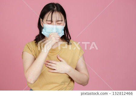 Health Awareness. Young woman with mask coughing, showing symptoms of illness. 132812466