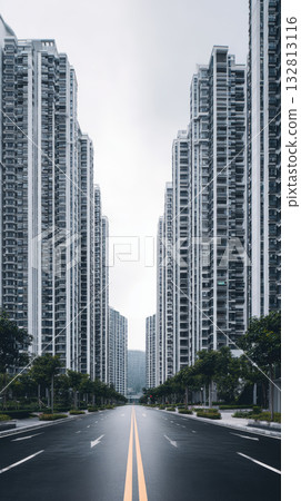 Highrise apartment building facade, urban residential towers, wide empty street, symmetrical perspective, overcast sky, modern cityscape 132813116