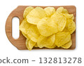 Potato chips on a wooden board close-up on a white. Top view 132813278