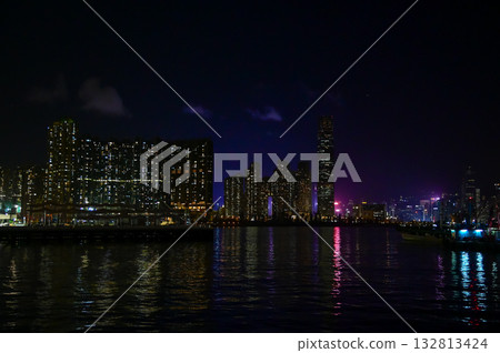 The night view of Hong Kong Island from the Kowloon. Hong Kong cityscape and seascape at night. Nature and city scene. 132813424