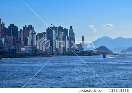 The view from Tsim Sha Tsui Victoria Harbour, Hong Kong. Iconic terminal and Hong Kong cityscape. Travel and nature scene. The view from Tsim Sha Tsui Victoria Harbour, Hong Kong. Iconic terminal and Hong Kong cityscape. Travel and nature scene. 132813518