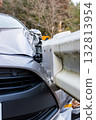 A passenger car that collided with a guardrail and sustained damage to the left front 132813954
