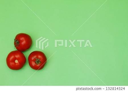 Fresh tomatos isolated on green background. Close up of tomatos. 132814324