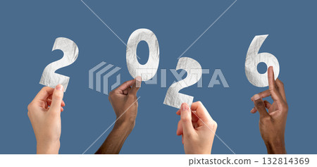 2026 new year celebration. Multiethnic team raising hands with metallic silver numbers, festive 2026 new year celebration. Multiethnic team raising hands with metallic silver numbers, festive 132814369