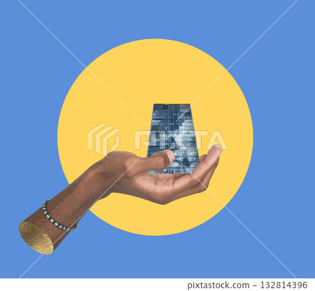 Building in hand architecture concept. African American male holding modern glass skyscraper and 132814396