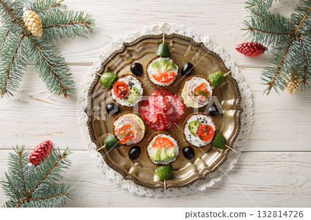 Christmas sandwich balls with cream cheese and fresh vegetables close-up in a plate. Horizontal top view 132814726