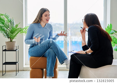 Young woman in a therapy session talking with a psychotherapist Young woman in a therapy session talking with a psychotherapist 132815005