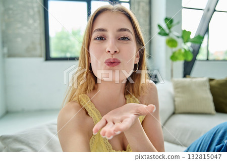 Close-up selfie portrait of teenage cheerful female looking at web camera Close-up selfie portrait of teenage cheerful female looking at web camera 132815047