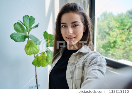 Close-up selfie portrait of teenage female looking at web camera Close-up selfie portrait of teenage female looking at web camera 132815110
