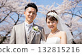 A wedding couple blessed by the spring breeze and cherry blossoms A wedding couple blessed by the spring breeze and cherry blossoms 132815216