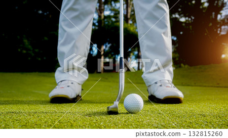 Golfers are putting golf in the evening golf course golf backglound. 132815260