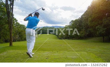 Golfer playing golf in the evening golf course, on sun set evening time. Golfer playing golf in the evening golf course, on sun set evening time. 132815262
