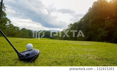 Golf clubs and balls on a green lawn in a beautiful golf course with morning sunshine. 132815263