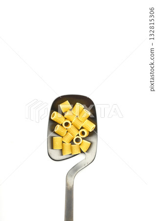 Raw pasta fusilli on wooden spoon on White background. Top view of Italian cuisine ingredient. 132815306