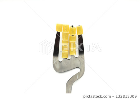 Raw pasta fusilli on wooden spoon on White background. Top view of Italian cuisine ingredient. Raw pasta fusilli on wooden spoon on White background. Top view of Italian cuisine ingredient. 132815309
