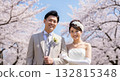A wedding couple blessed by the spring breeze and cherry blossoms A wedding couple blessed by the spring breeze and cherry blossoms 132815348